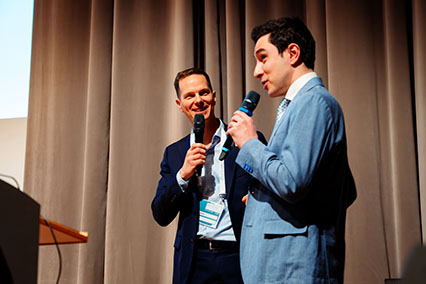 Alpha Ring expert shares a lighthearted anecdote during the company pitch on stage at binding.energy, highlighting the mission to deliver clean and accessible fusion energy with FusioNow™ technology
