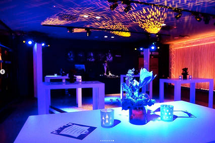 Evening ambiance at binding.energy with elegant lighting, modern white furniture, warm color accents, and stylish floral decor — creating a relaxed networking atmosphere for participants