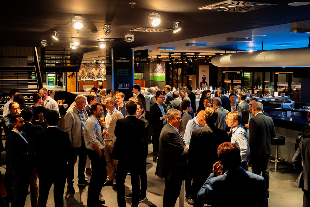 Participants of binding.energy from the nuclear fusion and fission sectors enjoy informal discussions at the Tivoli Stadium reception, including industry leaders, scientists, investors, and policy experts.