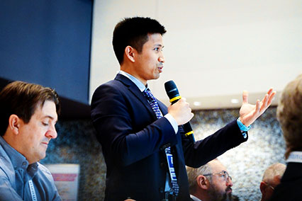 Audience member asks a question during the panel on synergies and learning between fusion and fission at the binding.energy nuclear conference