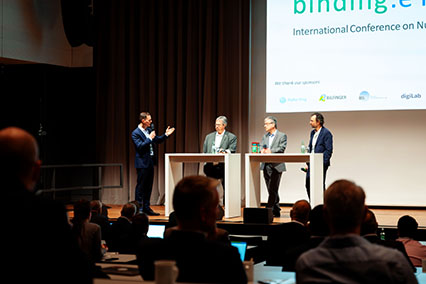 Fusion experts Markus Roth, Richard Kembleton, and Frank Jenko in discussion with moderator John Kettler on the main stage at the binding.energy panel on innovations in fusion technology
