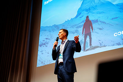 Moderator Dr. John Kettler engaging the audience on stage at binding.energy, combining his nuclear science expertise with two decades of experience in the nuclear industry and event leadership
