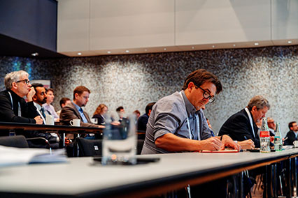 Participants take focused notes during the second session of the binding.energy conference on advancements in nuclear fission — from current systems to next-generation reactor technologies