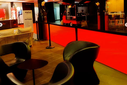 Quiet retreat space at the binding.energy conference venue with elegant black leather chairs, red carpeting, and tiled floors — ideal for focused laptop work or professional reading in a calm setting