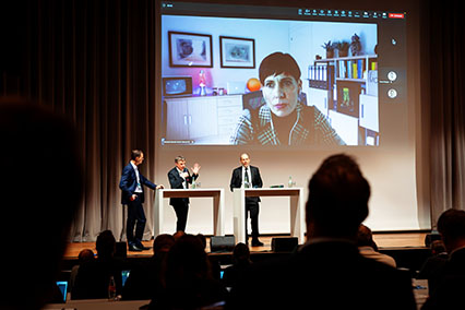 Dr. Meritxell Martell (GMF) appears via live video on the main screen at binding.energy to speak on community engagement in new nuclear technologies, alongside Dr. Duarte Borba (EUROfusion), Dr. Jens-Uwe Schmollack (TÜV Rheinland), and moderator on stage