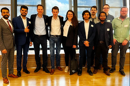 Group photo of young nuclear students and PhD candidates with binding.energy conference founder Dr. John Kettler, promoting the next generation in the fusion and fission sector