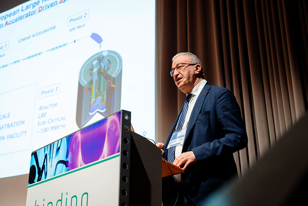 Prof. Dr. Hamid Aït Abderrahim presenting on MYRRHA and Accelerator Driven Systems during a TED-style expert talk at binding.energy conference, with live audience Q&A